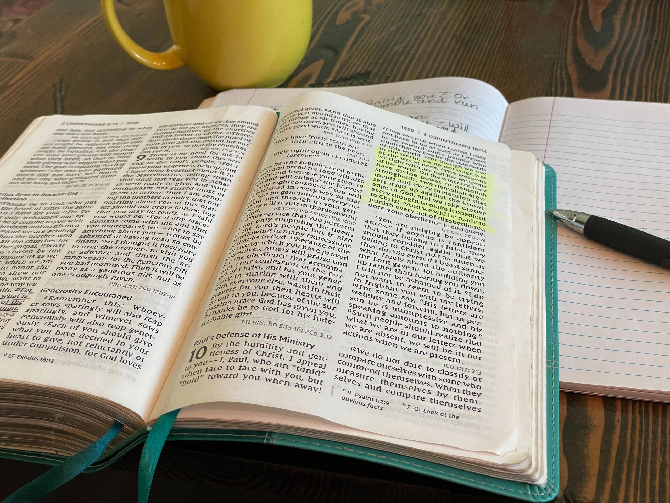 Open Bible with highlighted passage and notebook