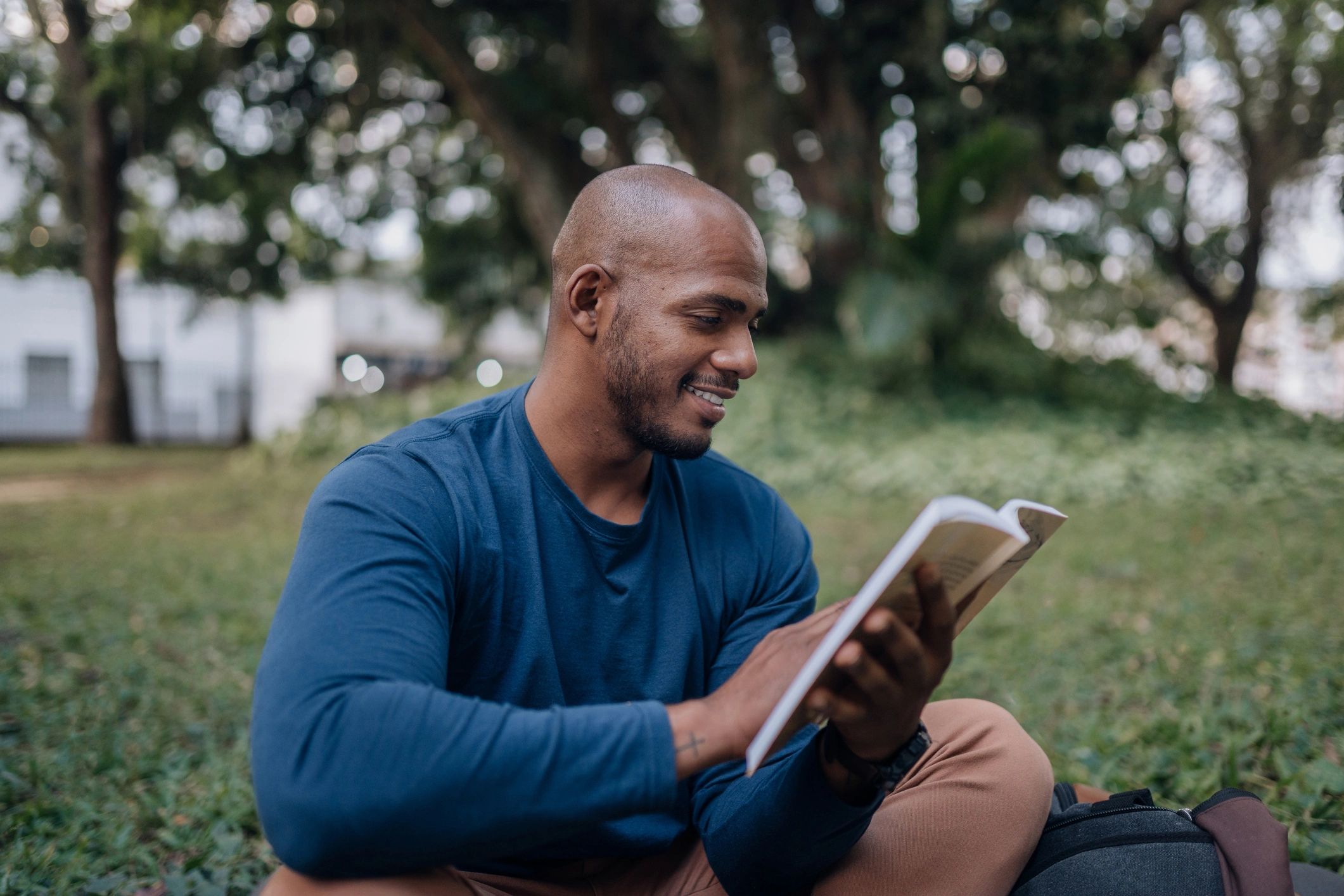 Person reading a book outdoors