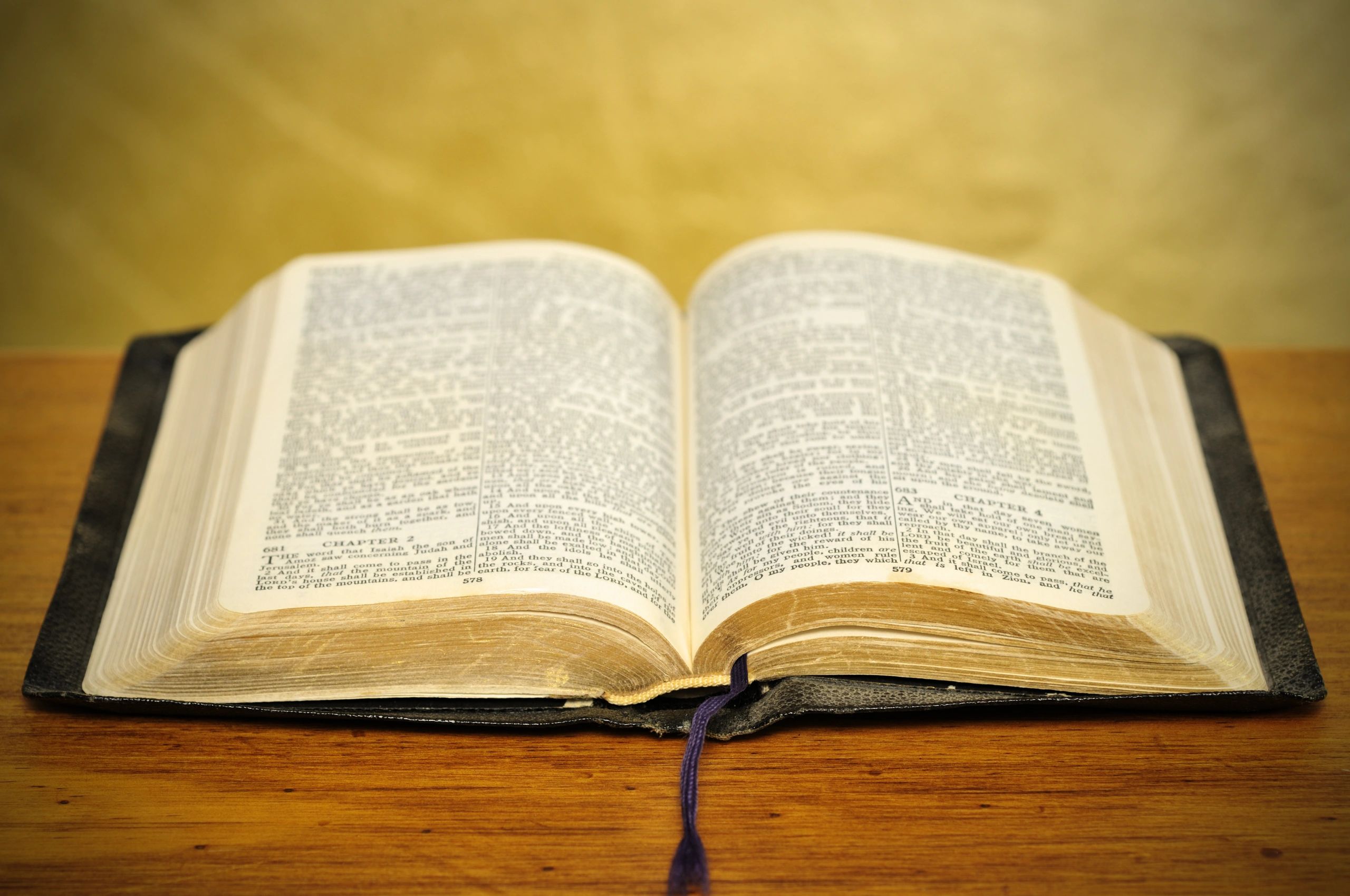 Well-used Bible on a wooden table