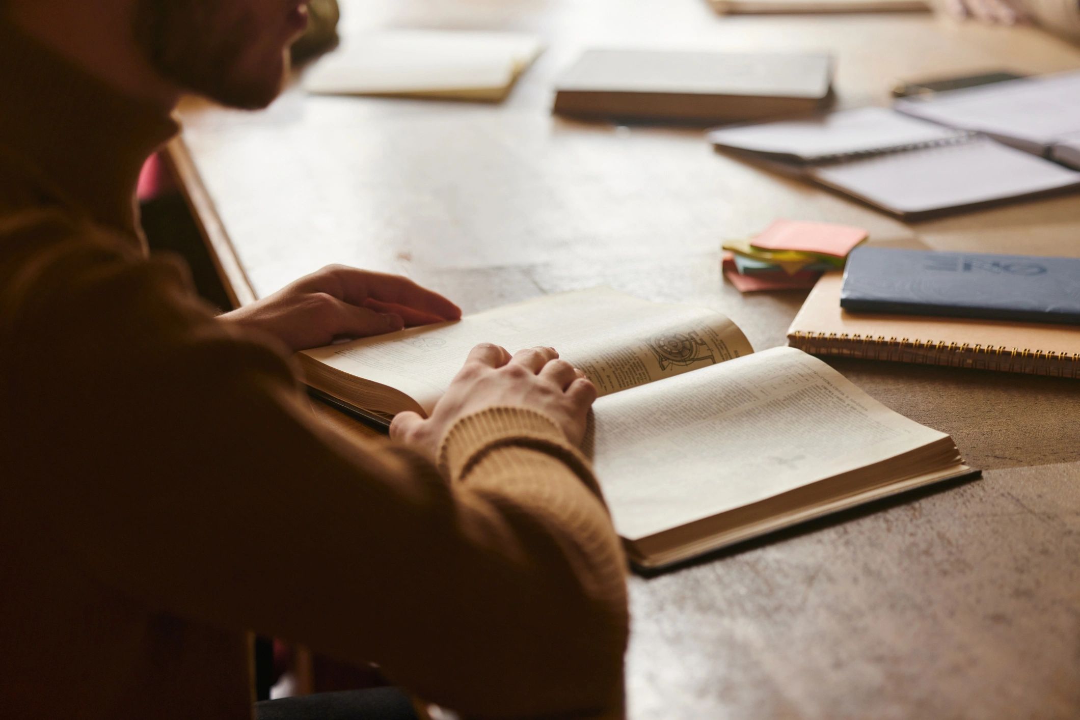Person reading a book in a library