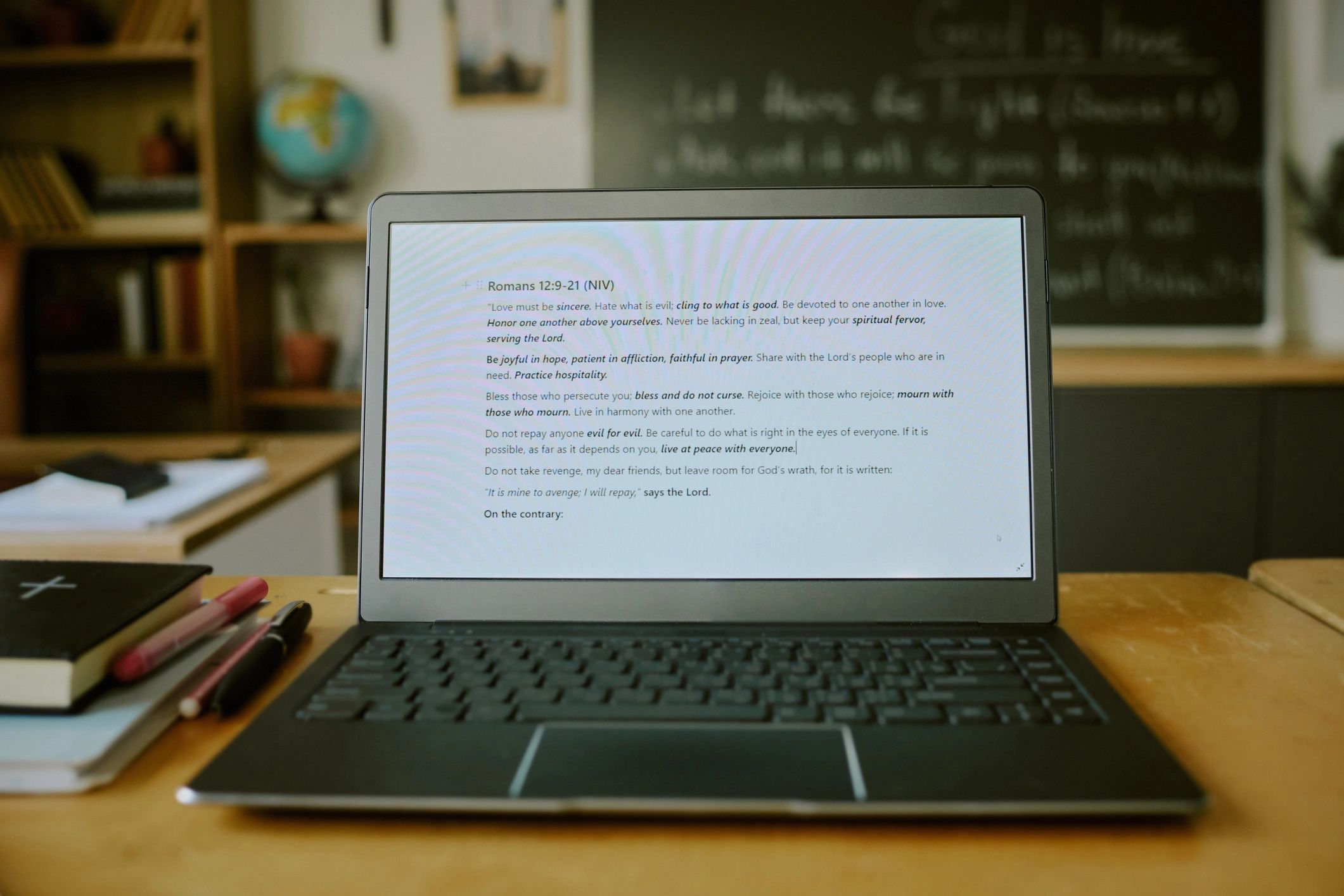 Open Bible and laptop on a desk for study